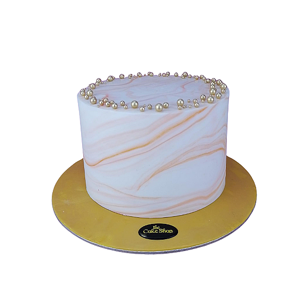 A cake adorned with golden decorations